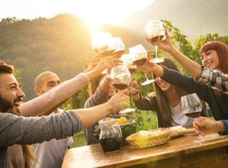 People raising wine glasses